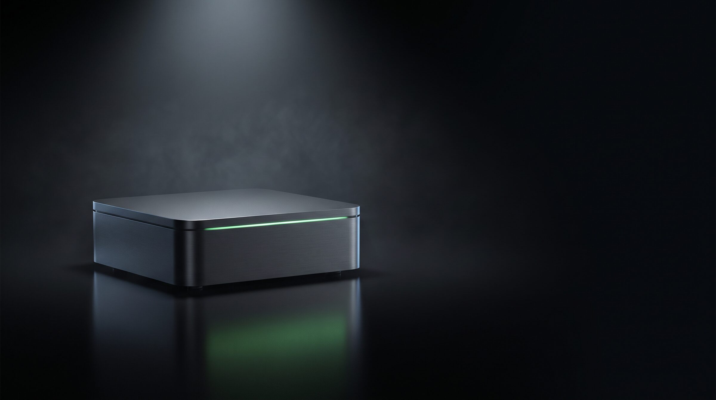 A small, minimal computer with a thin green light line, on a polished black surface